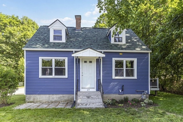 69 Powder Mill Rd, Maynard, MA 01754 - new england style home with a front lawn, a chimney, and roof with shingles
