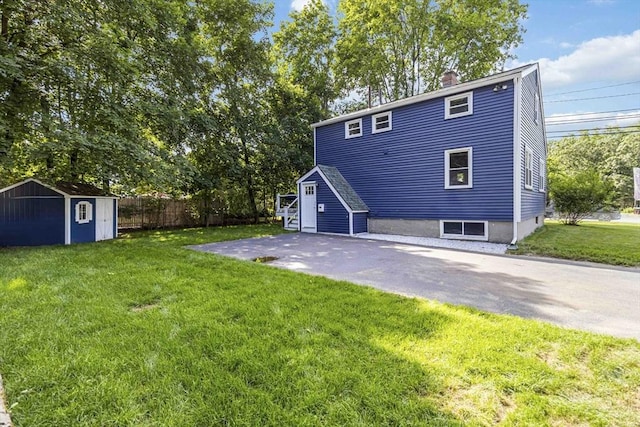 69 Powder Mill Rd, Maynard, MA 01754 - back of house with a storage shed and a chimney