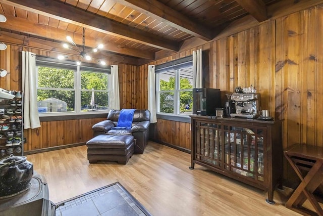 69 Powder Mill Rd, Maynard, MA 01754 - sitting room with wooden walls, a wood ceiling with exposed beams, wood finished floors, and a chandelier