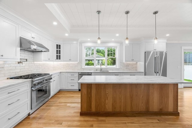 10 Whittier Rd, Natick, MA 01760 - kitchen featuring high end appliances, under cabinet range hood, ornamental molding, a kitchen island, and white cabinetry