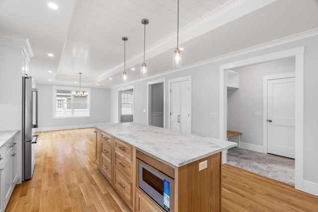 10 Whittier Rd, Natick, MA 01760 - kitchen featuring appliances with stainless steel finishes, light wood-style floors, white cabinets, pendant lighting, and light stone countertops
