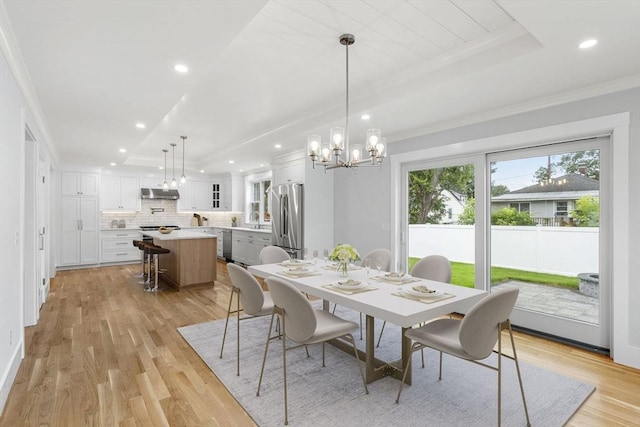 10 Whittier Rd, Natick, MA 01760 - dining area featuring a chandelier, a raised ceiling, recessed lighting, light wood-type flooring, and crown molding