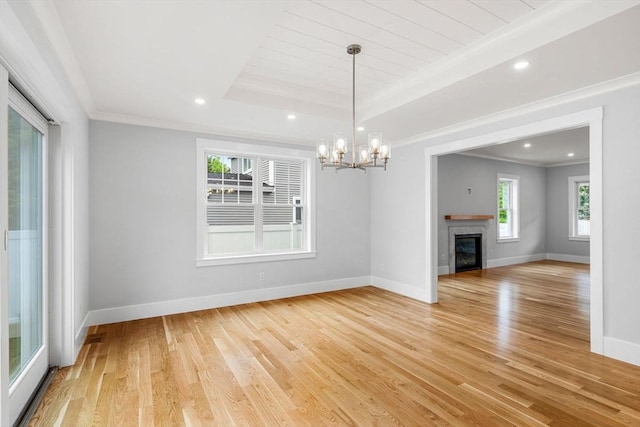 10 Whittier Rd, Natick, MA 01760 - unfurnished living room with light wood-style flooring, ornamental molding, a chandelier, recessed lighting, and a glass covered fireplace