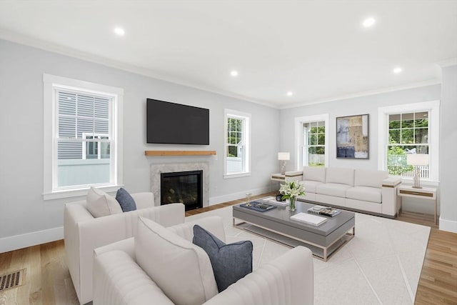 10 Whittier Rd, Natick, MA 01760 - living room with ornamental molding, wood finished floors, a premium fireplace, and recessed lighting