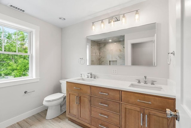 10 Whittier Rd, Natick, MA 01760 - full bathroom featuring plenty of natural light, double vanity, a marble finish shower, and wood finished floors