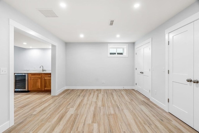 10 Whittier Rd, Natick, MA 01760 - below grade area with wine cooler, bar with sink, light wood finished floors, and recessed lighting