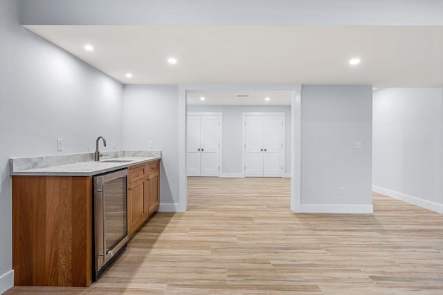 10 Whittier Rd, Natick, MA 01760 - kitchen featuring beverage cooler, recessed lighting, light wood finished floors, brown cabinetry, and light countertops