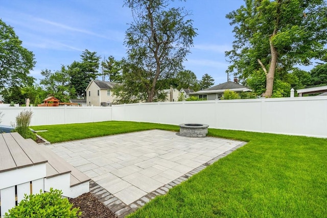 10 Whittier Rd, Natick, MA 01760 - fenced backyard with a patio area and a fire pit