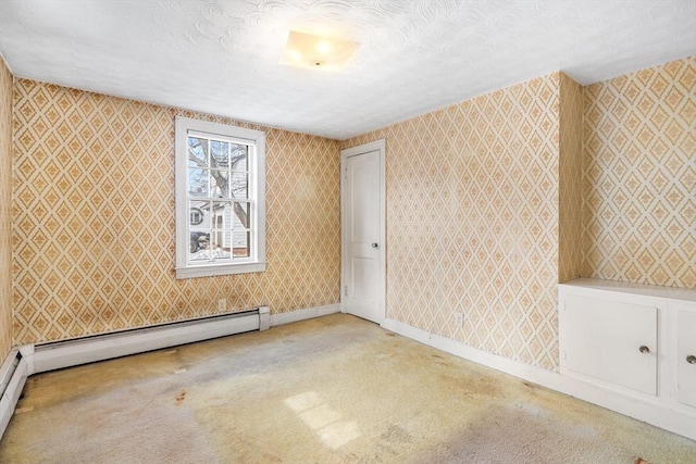 empty room with carpet flooring, a textured ceiling, baseboards, and wallpapered walls