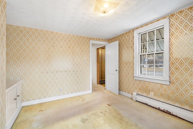 carpeted empty room with a baseboard radiator, a textured ceiling, baseboards, and wallpapered walls