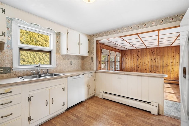 kitchen with plenty of natural light, a baseboard radiator, white dishwasher, and a sink