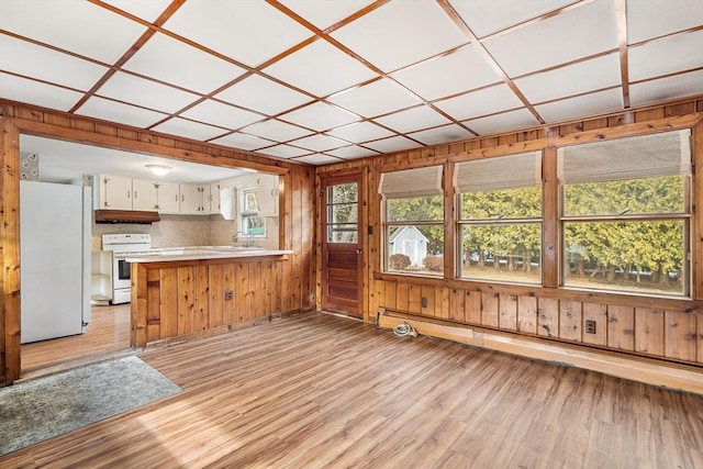 kitchen with light countertops, white appliances, white cabinets, and light wood finished floors