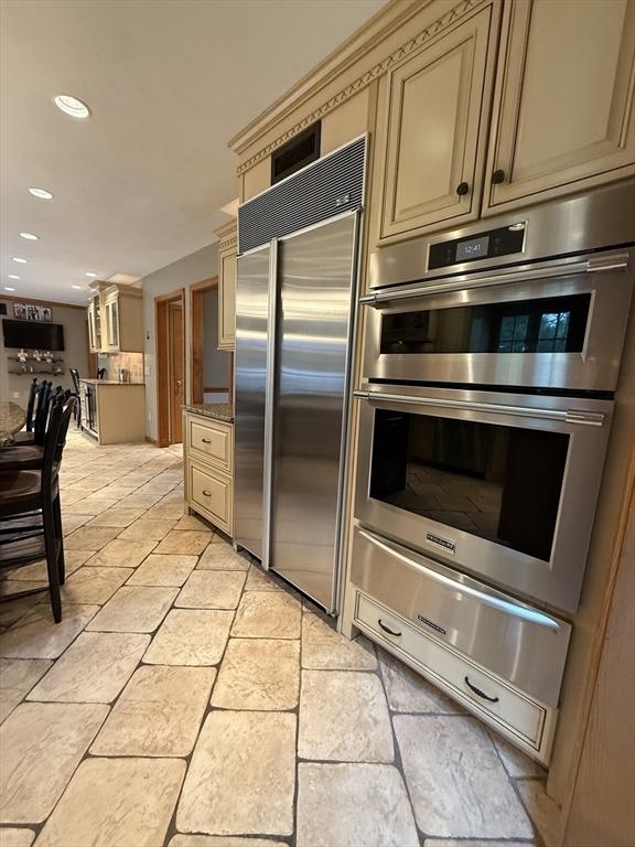 15 Wenlock Cir, Easton, MA 02356 - kitchen with appliances with stainless steel finishes, cream cabinetry, a warming drawer, and recessed lighting