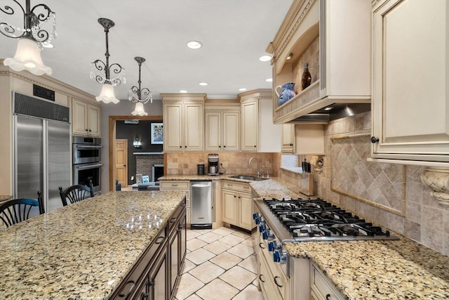 15 Wenlock Cir, Easton, MA 02356 - kitchen with cream cabinetry, stainless steel appliances, a sink, light stone countertops, and hanging light fixtures