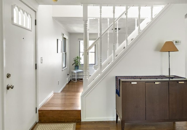 58 Edward Rd, Watertown, MA 02472 - entrance foyer with stairway, wood finished floors, baseboards, and a baseboard heating unit
