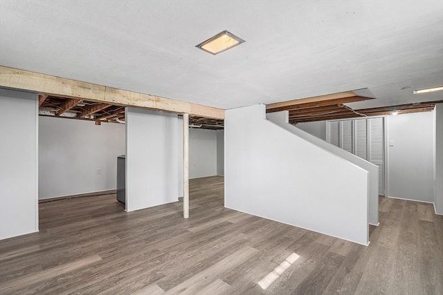 finished basement with wood finished floors and stairs