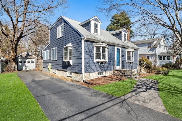 cape cod house with a detached garage, an outbuilding, driveway, and a front lawn