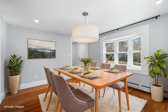 dining space featuring recessed lighting, wood finished floors, baseboards, and a baseboard radiator