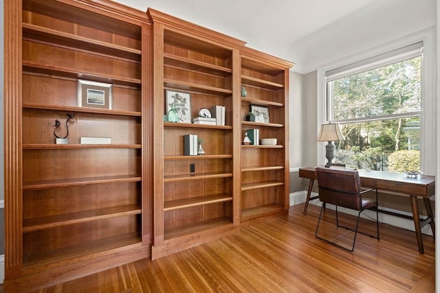 interior space featuring baseboards and wood finished floors