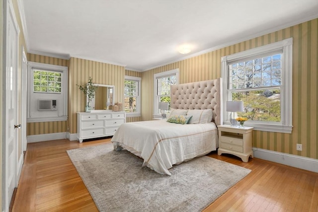 bedroom with wood-type flooring, baseboards, and multiple windows