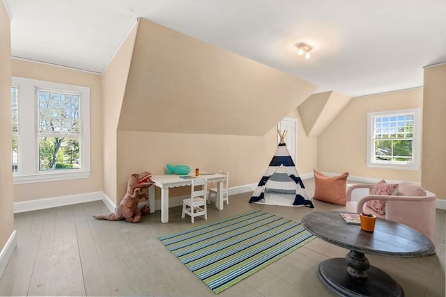 rec room featuring baseboards and lofted ceiling