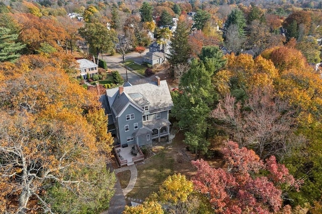 drone / aerial view with a wooded view