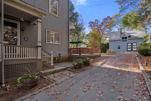 view of home's exterior with a patio and a wooden deck