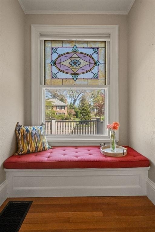details featuring visible vents, ornamental molding, and wood finished floors