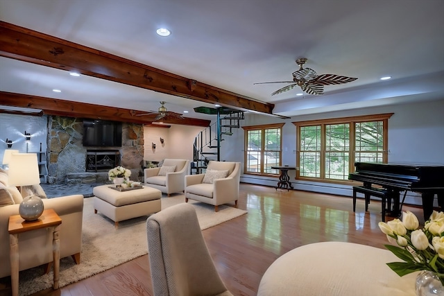 living room featuring beam ceiling, light hardwood / wood-style flooring, and ceiling fan