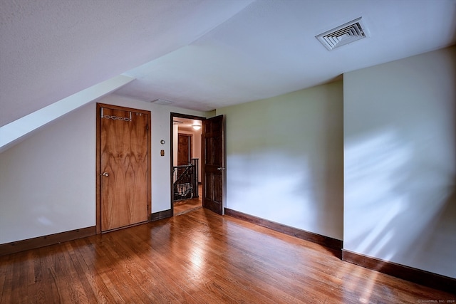 bonus room with wood-type flooring