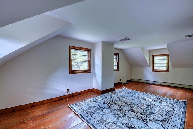 bonus room with wood-type flooring, a baseboard radiator, and lofted ceiling