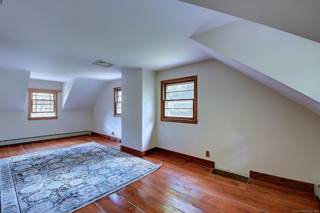 bonus room featuring hardwood / wood-style flooring, baseboard heating, and vaulted ceiling