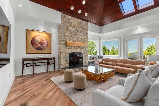 6 Wayside Cir, Framingham, MA 01701 - living area featuring a towering ceiling, a stone fireplace, wood finished floors, recessed lighting, and a skylight