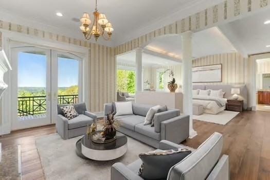 6 Wayside Cir, Framingham, MA 01701 - living room with wood finished floors, a chandelier, wallpapered walls, french doors, and crown molding