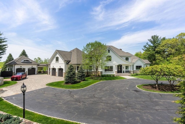 6 Wayside Cir, Framingham, MA 01701 - french country home with curved driveway, stucco siding, and a garage