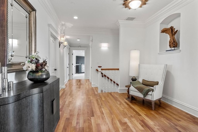 6 Wayside Cir, Framingham, MA 01701 - hallway with an upstairs landing, light wood finished floors, baseboards, ornamental molding, and recessed lighting