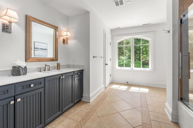 6 Wayside Cir, Framingham, MA 01701 - full bath featuring vanity, an enclosed shower, tile patterned flooring, and baseboards