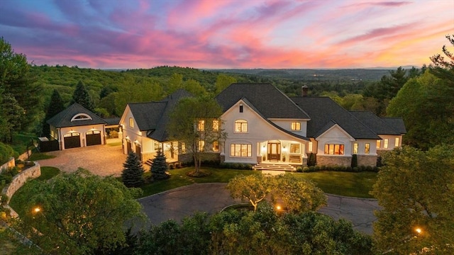 6 Wayside Cir, Framingham, MA 01701 - french country inspired facade with driveway, stucco siding, a garage, and a wooded view