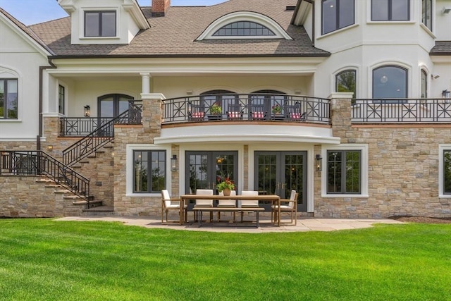 6 Wayside Cir, Framingham, MA 01701 - back of property featuring french doors, stone siding, a balcony, and a lawn