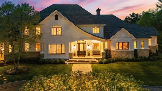 6 Wayside Cir, Framingham, MA 01701 - view of front of house with stucco siding, a chimney, stone siding, and a front yard