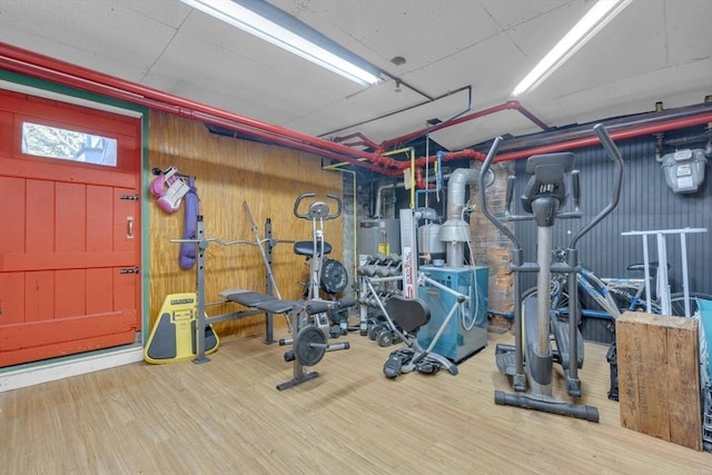 exercise room with wood finished floors