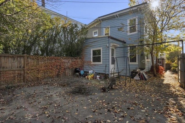 back of property with fence