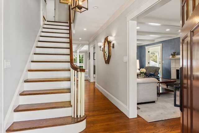 stairway with recessed lighting, plenty of natural light, and wood finished floors