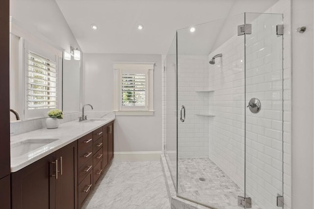 full bath featuring a sink, a healthy amount of sunlight, and lofted ceiling