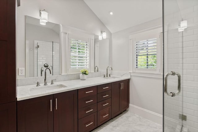 full bath with a sink, plenty of natural light, and vaulted ceiling