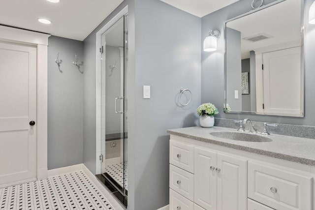 full bathroom featuring visible vents, a shower stall, vanity, baseboards, and recessed lighting