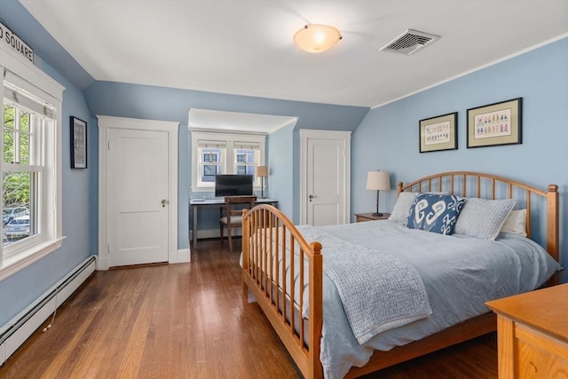 bedroom with a baseboard heating unit, lofted ceiling, wood finished floors, and visible vents