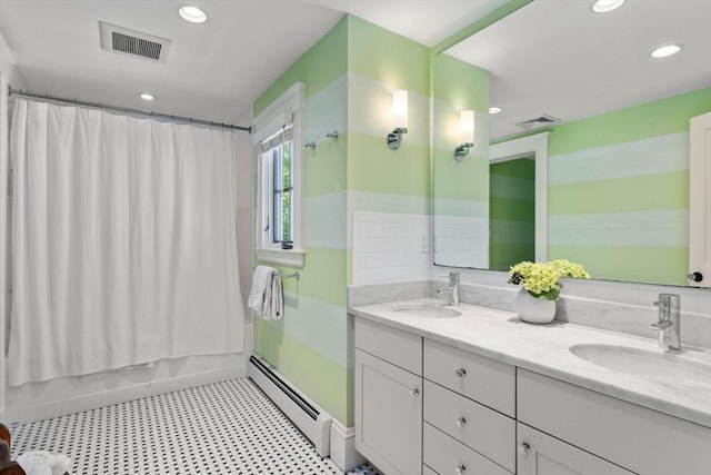 full bath featuring visible vents, a sink, and a baseboard heating unit