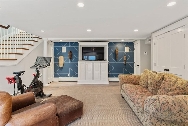 living area featuring light wood-style floors, recessed lighting, and stairs