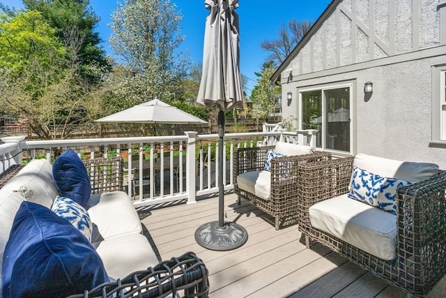 wooden deck with a fenced backyard